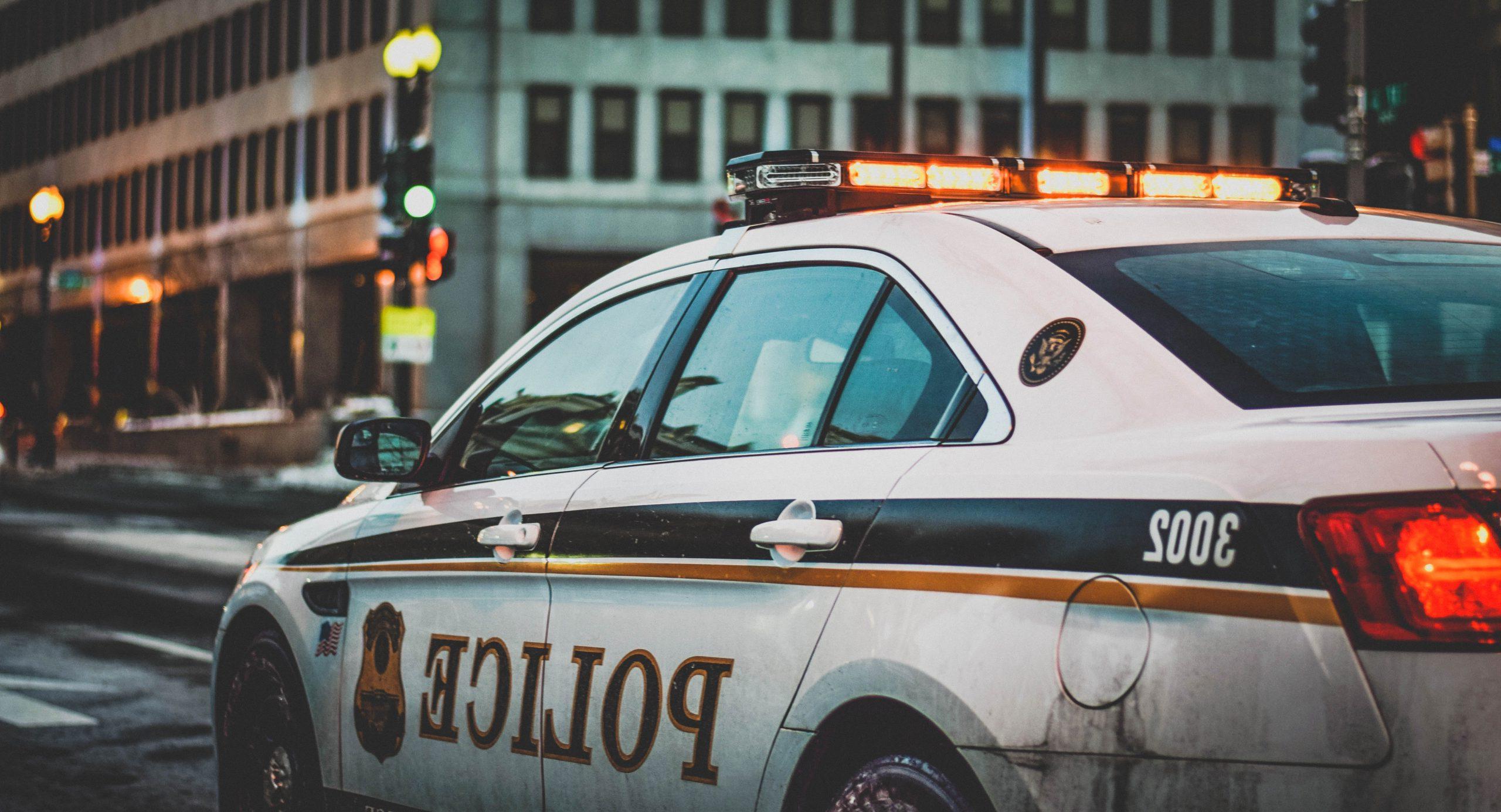 A police cruiser on the street in the city.